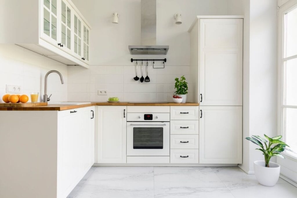 Remodeled Small Apartment Kitchen With White Cabinets