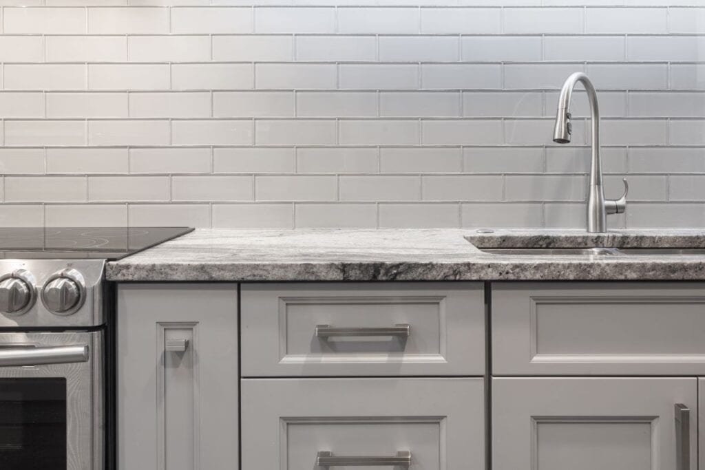 Kitchen with white tile backsplash