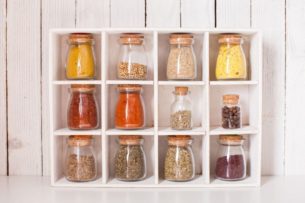 Spices on display in glass jars in the kitchen for decoration