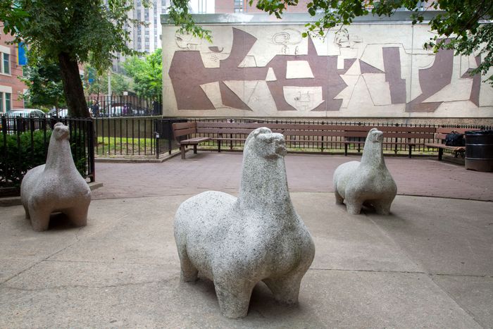 A group of abstract, squat concrete horse statues