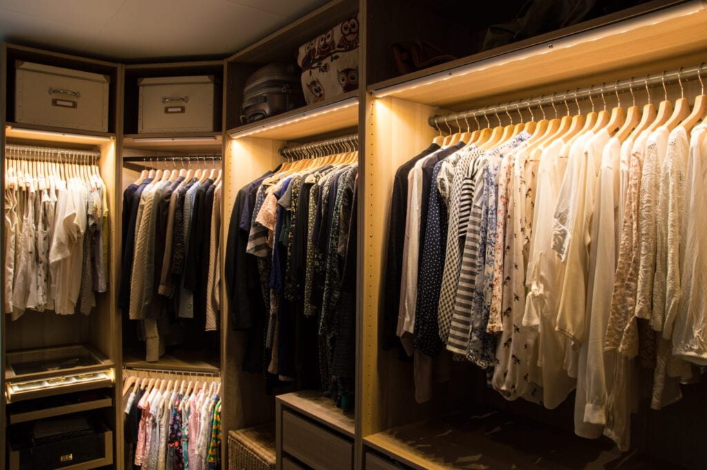 Luxurious dressing room with lighting and jewelry display.