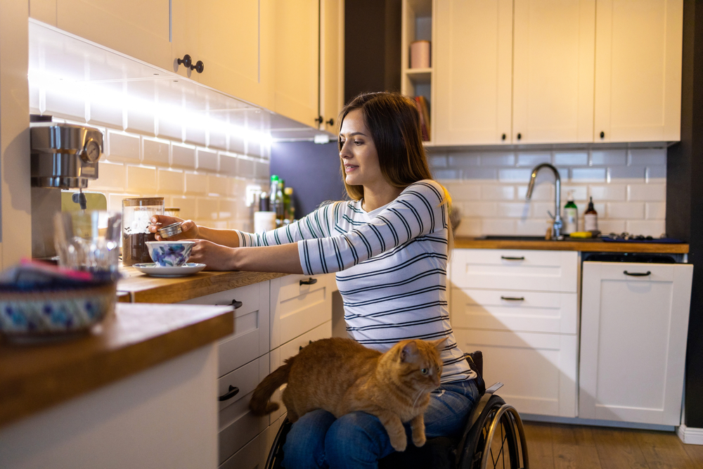 woman in wheelchair in apartment kitchen