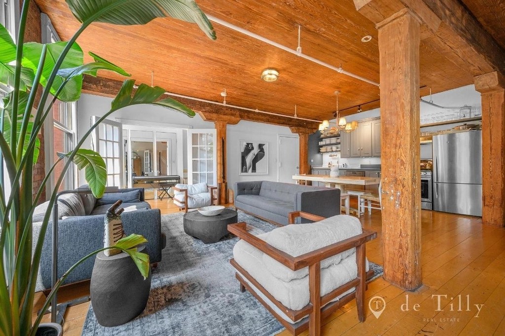 Unique living room with wooden beams and a ceiling