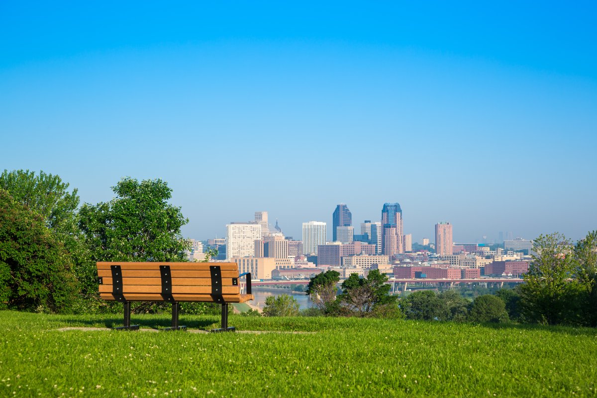 The St. Paul skyline as seen from a park bench from far away on a clear, sunny day.