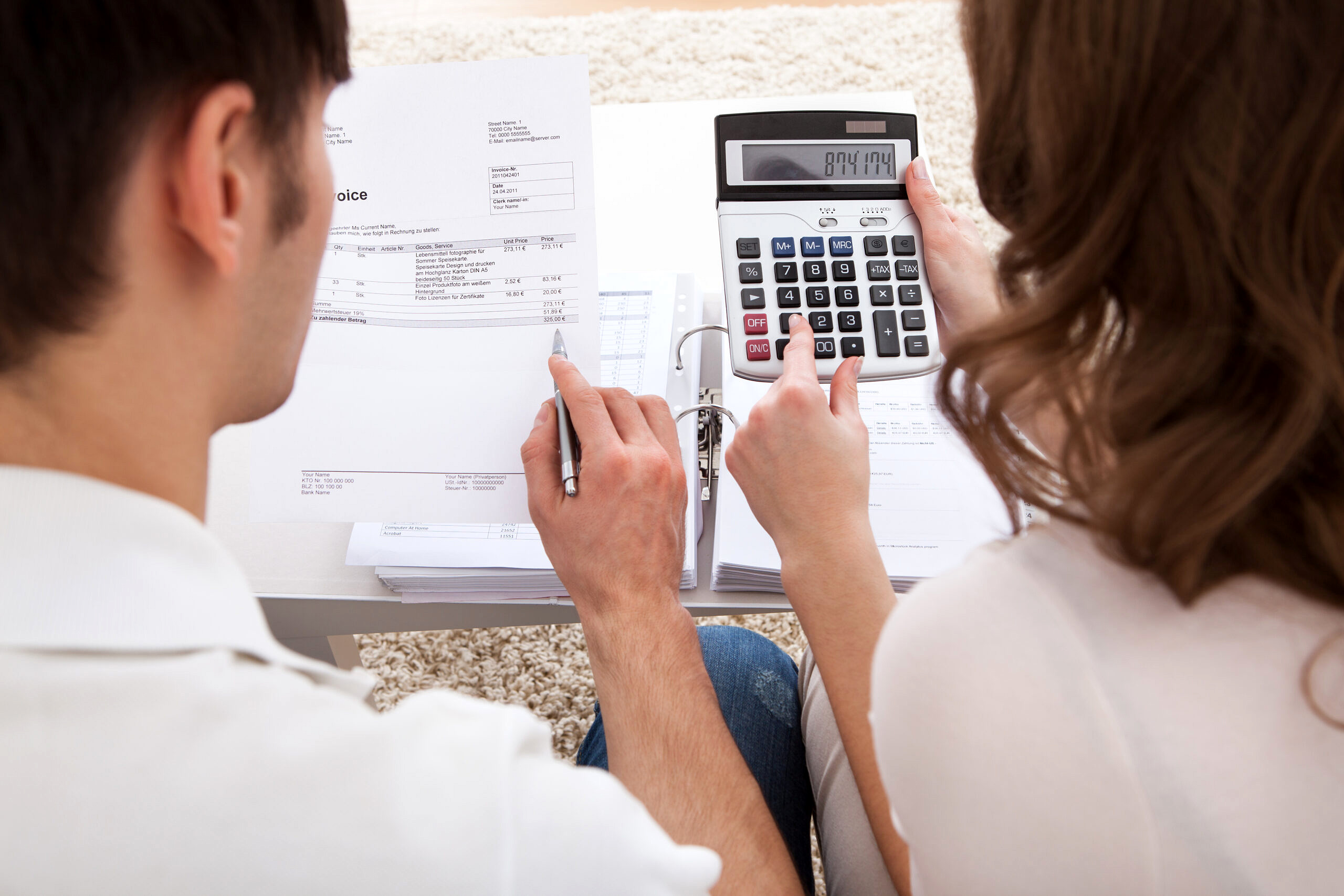 Portrait of young happy couple calculating budget