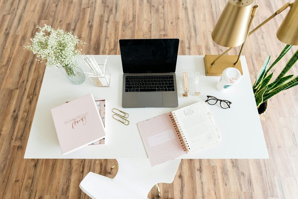 desk set up with papers and other miscellaneous items