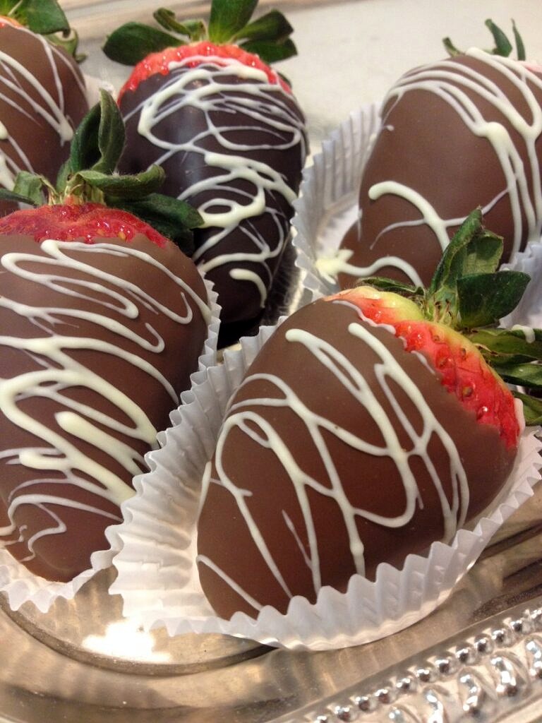 Strawberries covered with chocolate with whirlpools of white chocolate made by beaverdale confectionery to monks, ia.