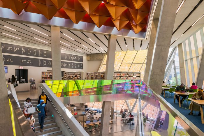 In Far Rockaway, metal origami on the ceiling is intended to diffuse sound; Dichroic glass balustrades change color when you pass.